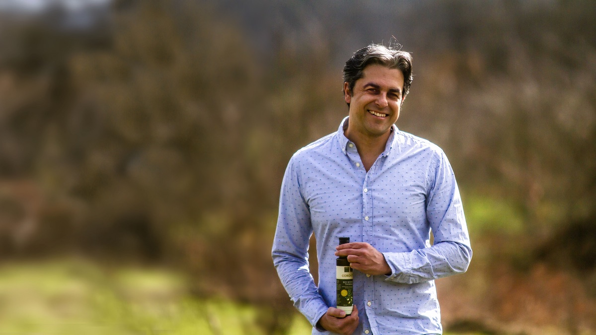 Corovita: portrait with a bottle of olive oil, the hero image from corovita.com